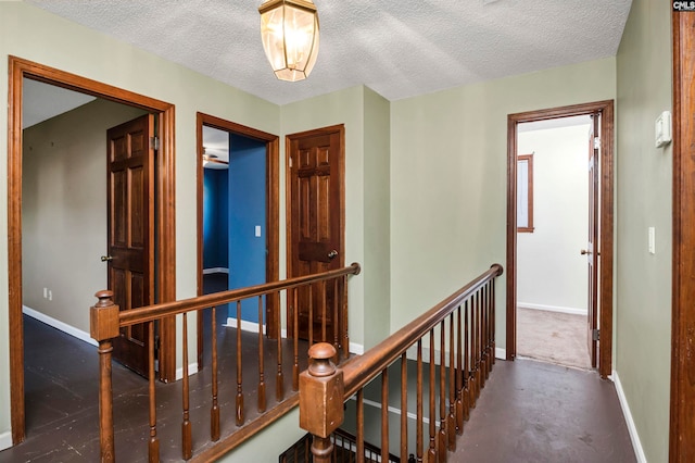 hall featuring a textured ceiling