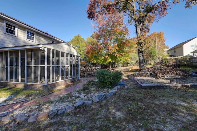 view of yard featuring a sunroom