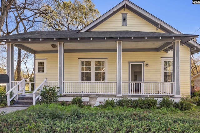 rear view of property featuring a porch