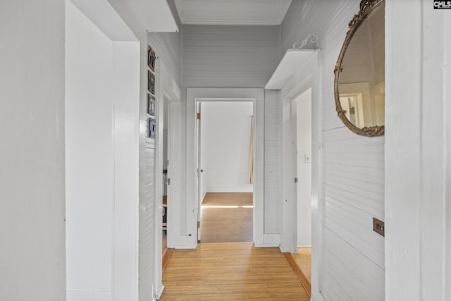 corridor featuring wood walls and light hardwood / wood-style floors