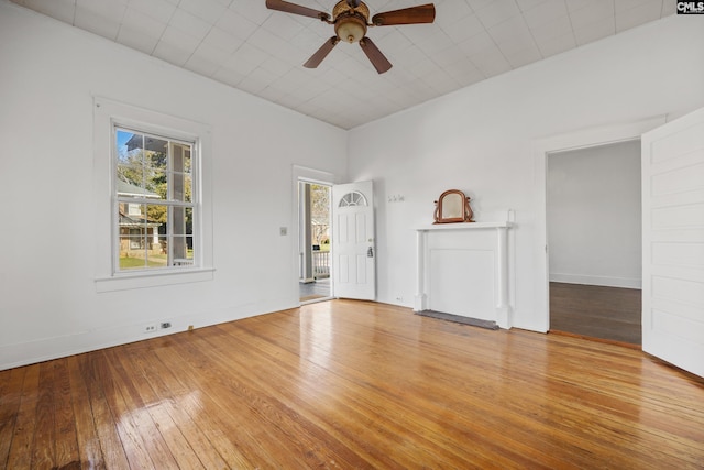 unfurnished living room featuring ceiling fan and light hardwood / wood-style floors