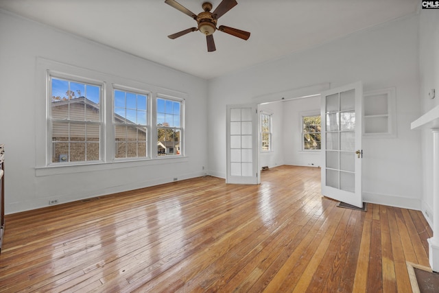 empty room featuring french doors, light hardwood / wood-style floors, and ceiling fan