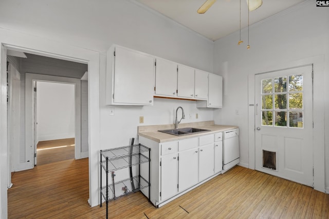 kitchen featuring dishwasher, light hardwood / wood-style flooring, white cabinetry, and sink