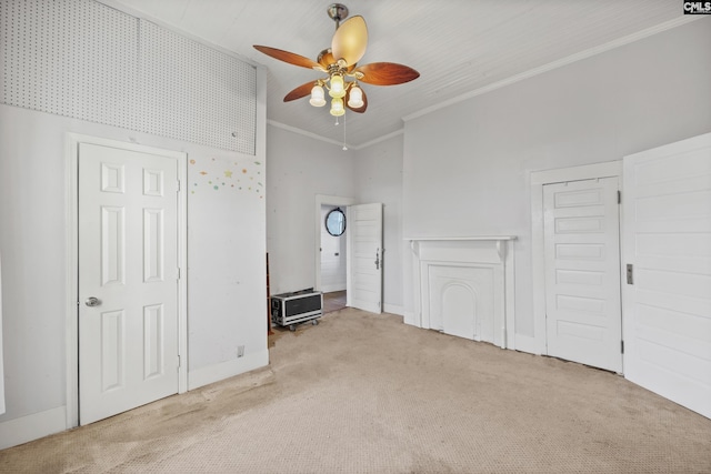 interior space with light carpet, a towering ceiling, ceiling fan, and crown molding