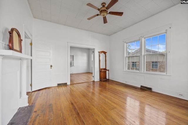 unfurnished living room with hardwood / wood-style floors and ceiling fan