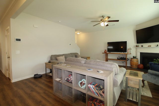 living room featuring ceiling fan and dark wood-type flooring