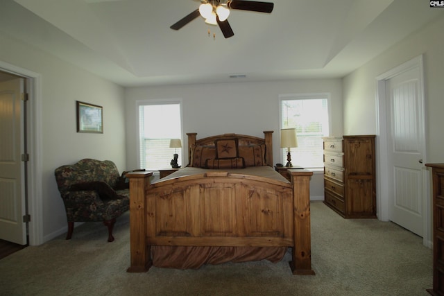 bedroom with ceiling fan and light colored carpet