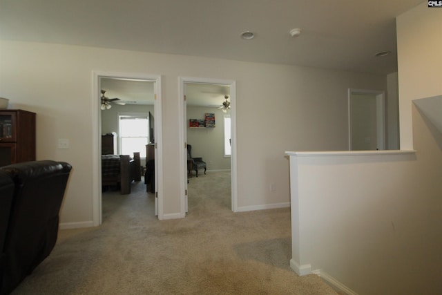 hallway featuring light carpet