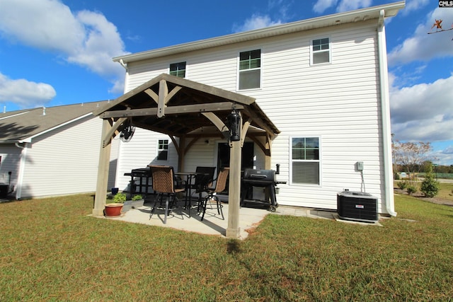 rear view of property featuring a gazebo, a patio, cooling unit, and a lawn