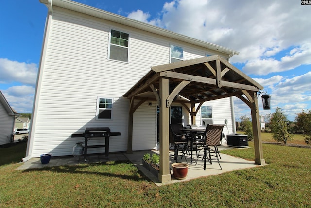 rear view of house with a lawn, a patio, central AC unit, and a gazebo