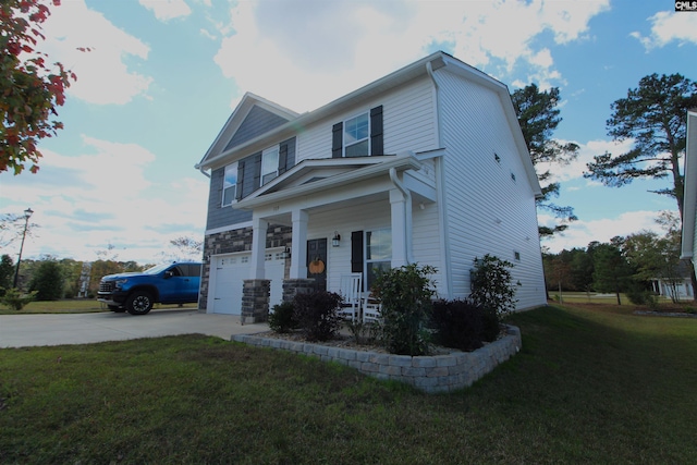 view of front of property featuring a front yard, a garage, and covered porch