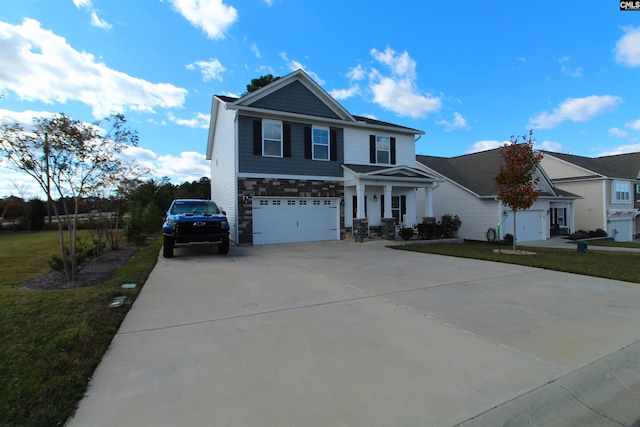 view of property featuring a garage and a front lawn