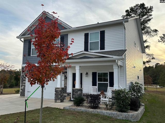 view of front of house featuring a porch and a garage