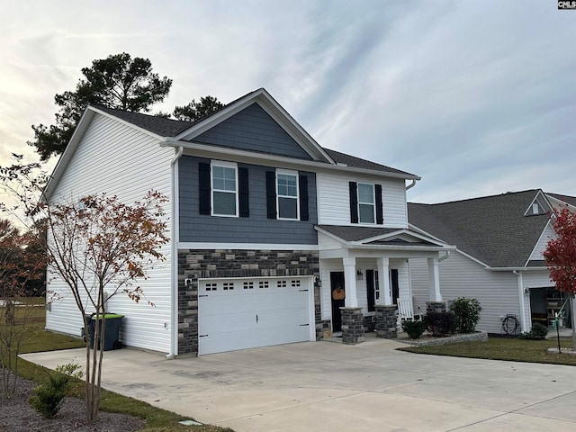 view of front of property with a porch and a garage