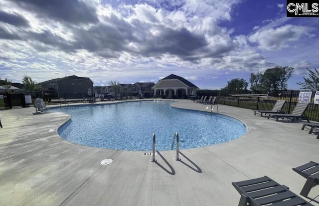 view of swimming pool with a patio area