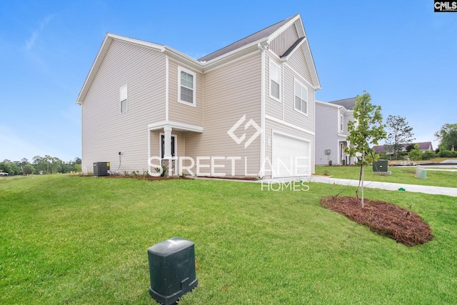 view of side of property featuring central AC, a yard, and a garage