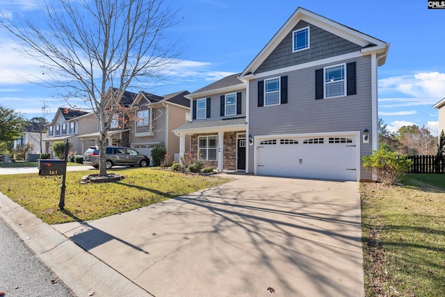 view of front of property featuring a front yard and a garage