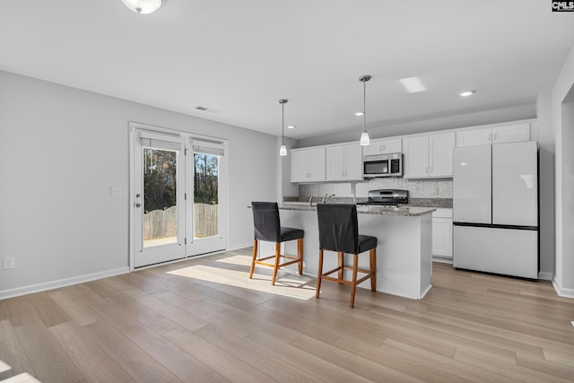 kitchen featuring white cabinetry, light hardwood / wood-style flooring, and stainless steel appliances