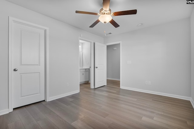 unfurnished bedroom with ceiling fan and light wood-type flooring