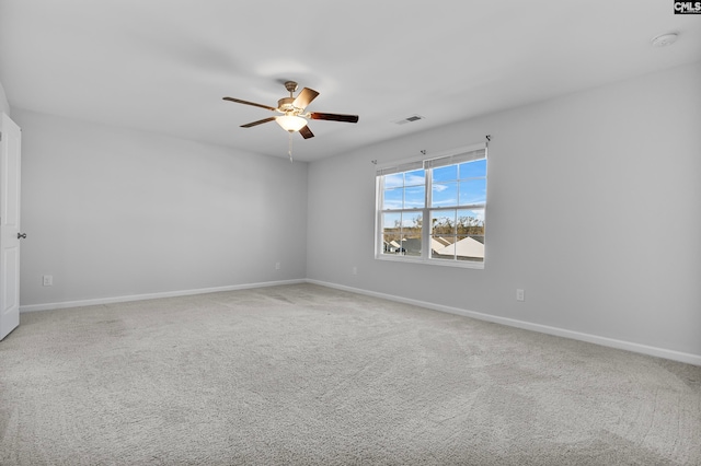 spare room featuring ceiling fan and carpet floors