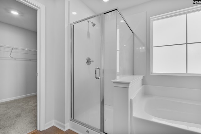 bathroom with separate shower and tub