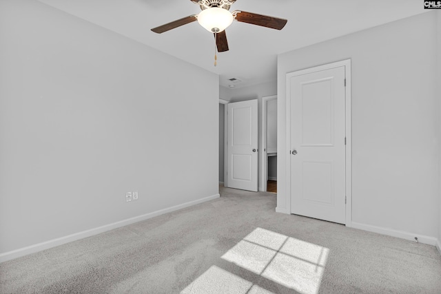 unfurnished bedroom with ceiling fan and light carpet