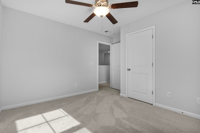 unfurnished bedroom with ceiling fan and light carpet