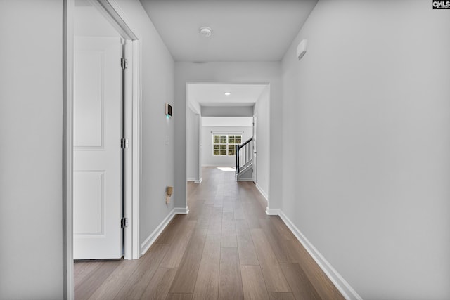 hallway with light hardwood / wood-style floors