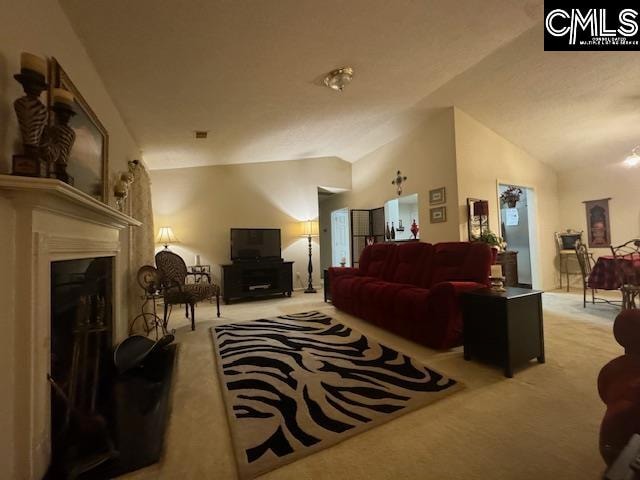 carpeted living room featuring vaulted ceiling