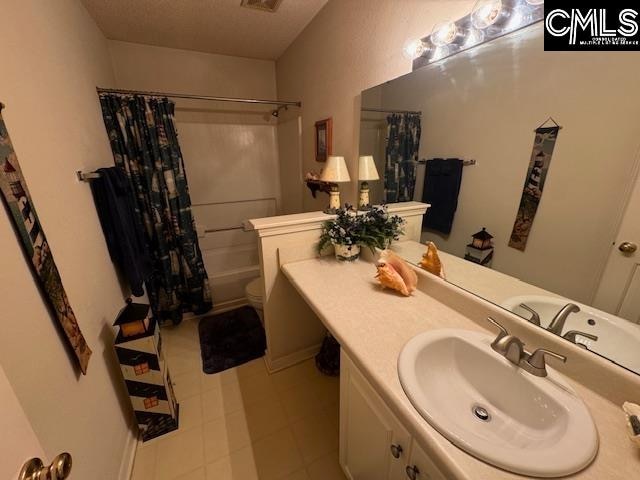 full bathroom with vanity, toilet, and shower / tub combo