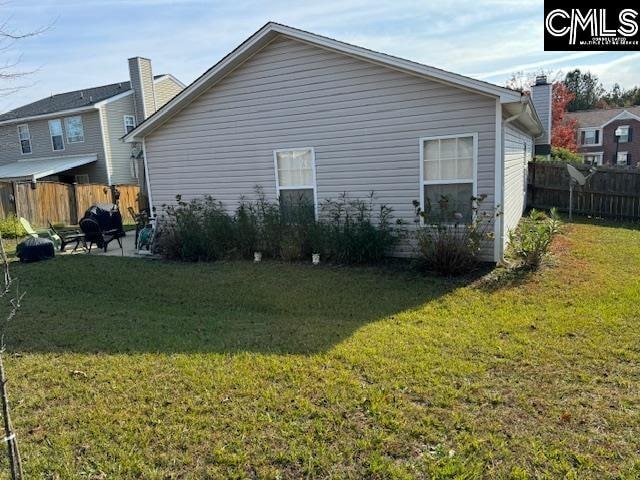 view of property exterior with a lawn