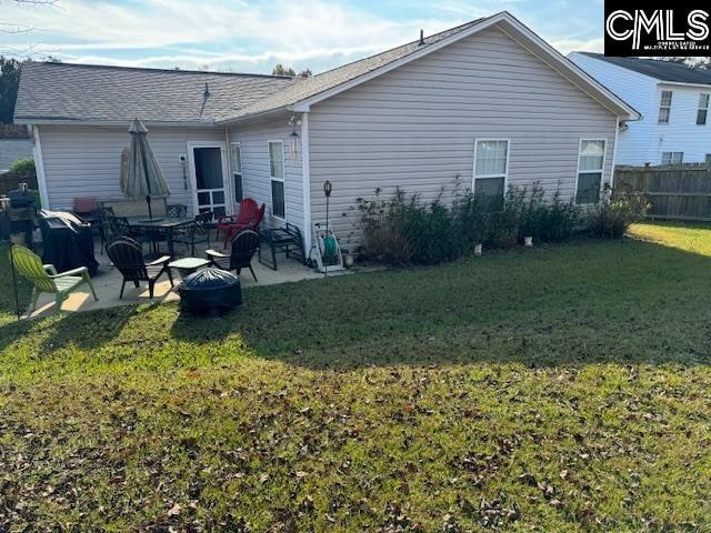 back of house featuring a yard and a patio