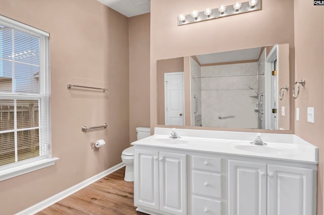 bathroom featuring walk in shower, hardwood / wood-style floors, vanity, and toilet