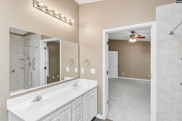 bathroom with a tile shower, vanity, and ceiling fan