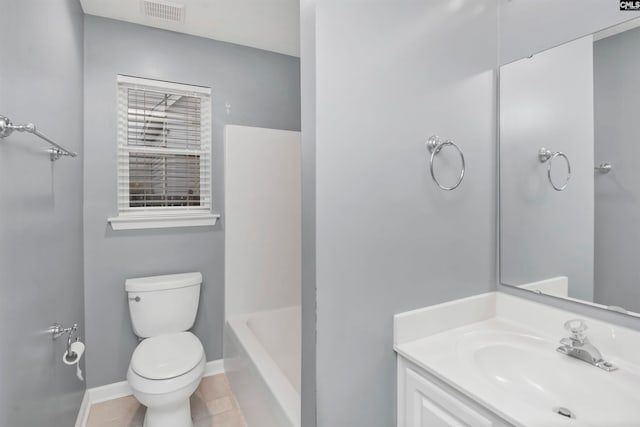 bathroom with tile patterned flooring, vanity, and toilet