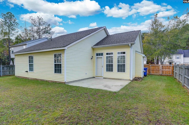 back of property featuring a lawn and a patio