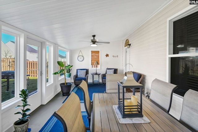 sunroom / solarium featuring ceiling fan