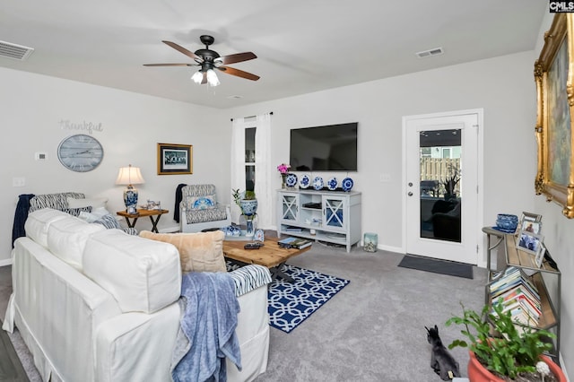 carpeted living room featuring ceiling fan