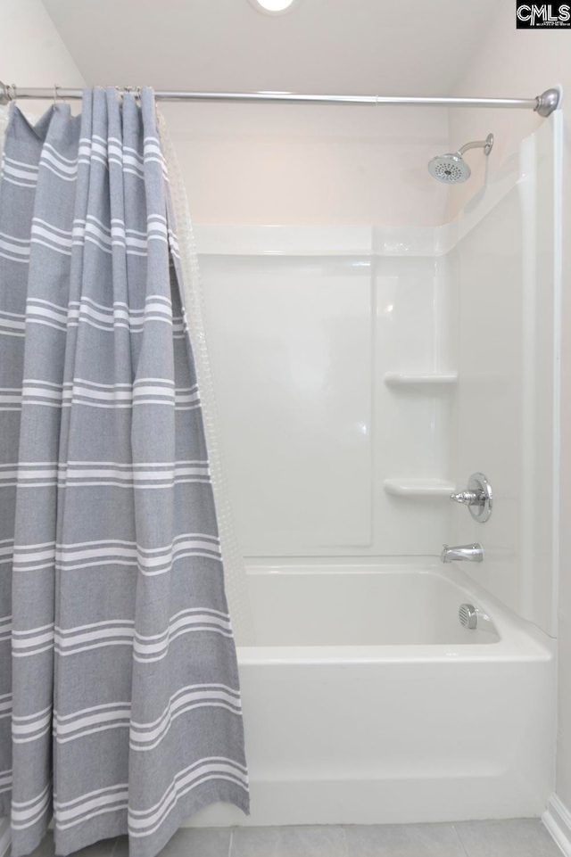 bathroom with tile patterned floors and shower / tub combo with curtain