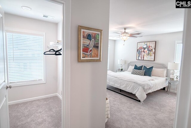 bedroom featuring light carpet and ceiling fan