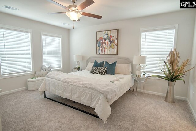 bedroom featuring ceiling fan and light carpet