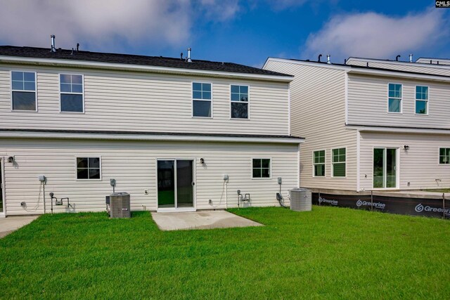 rear view of house featuring a yard, cooling unit, and a patio area