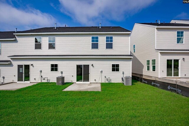 rear view of property with central air condition unit, a yard, and a patio