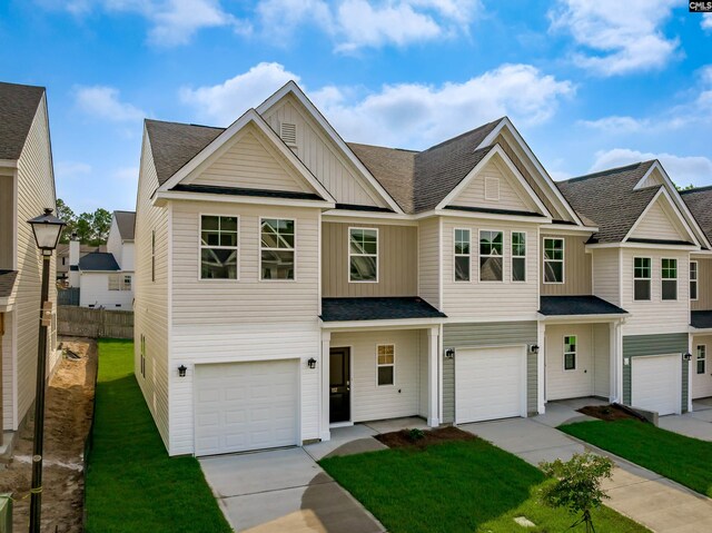 view of front of property featuring a front yard and a garage