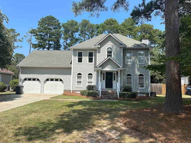 colonial inspired home with a front yard, a garage, and cooling unit