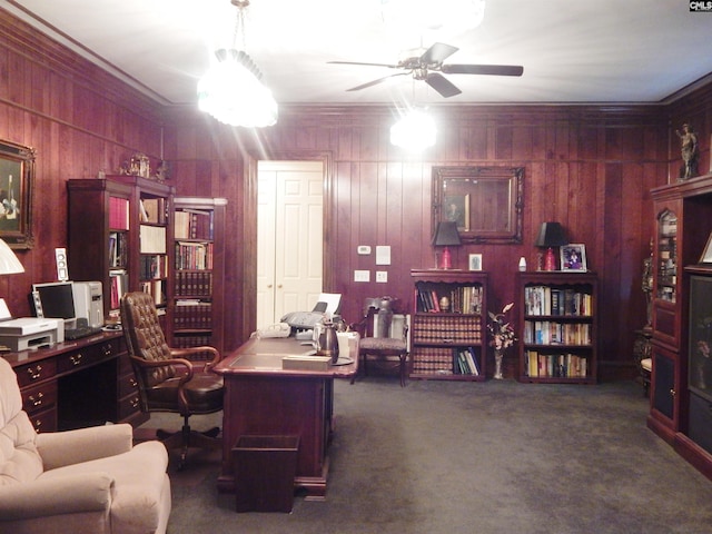 carpeted home office featuring wooden walls and ornamental molding