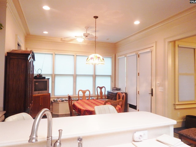 kitchen with crown molding and hanging light fixtures