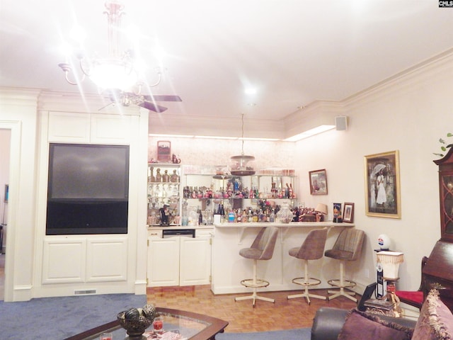 living room with ornamental molding and bar area