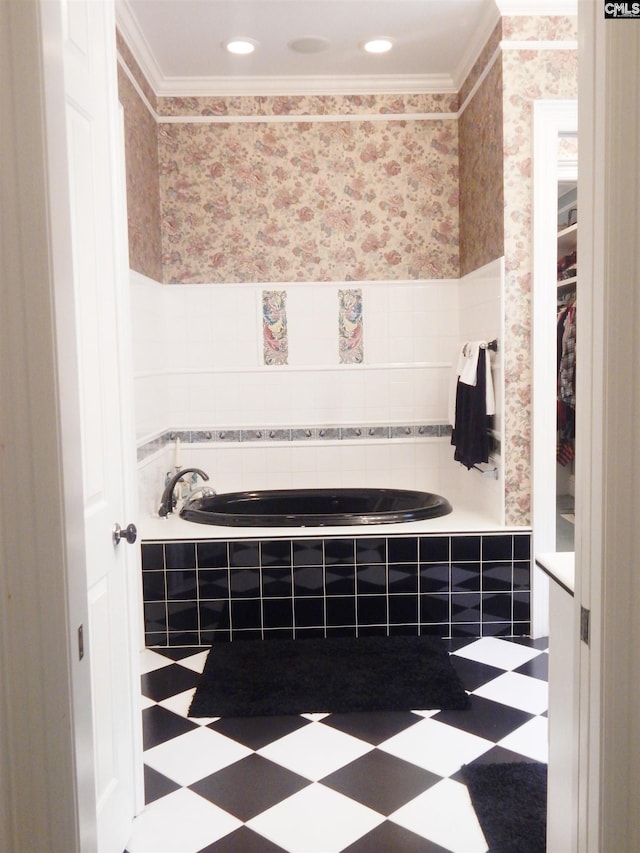 bathroom with tiled tub and crown molding