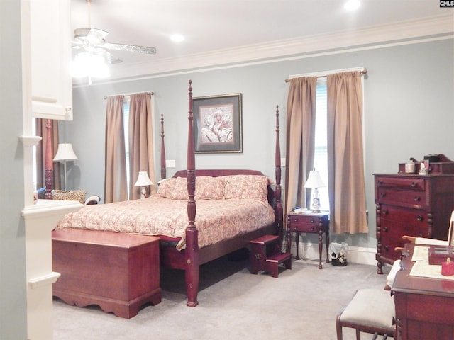 carpeted bedroom with ceiling fan and crown molding